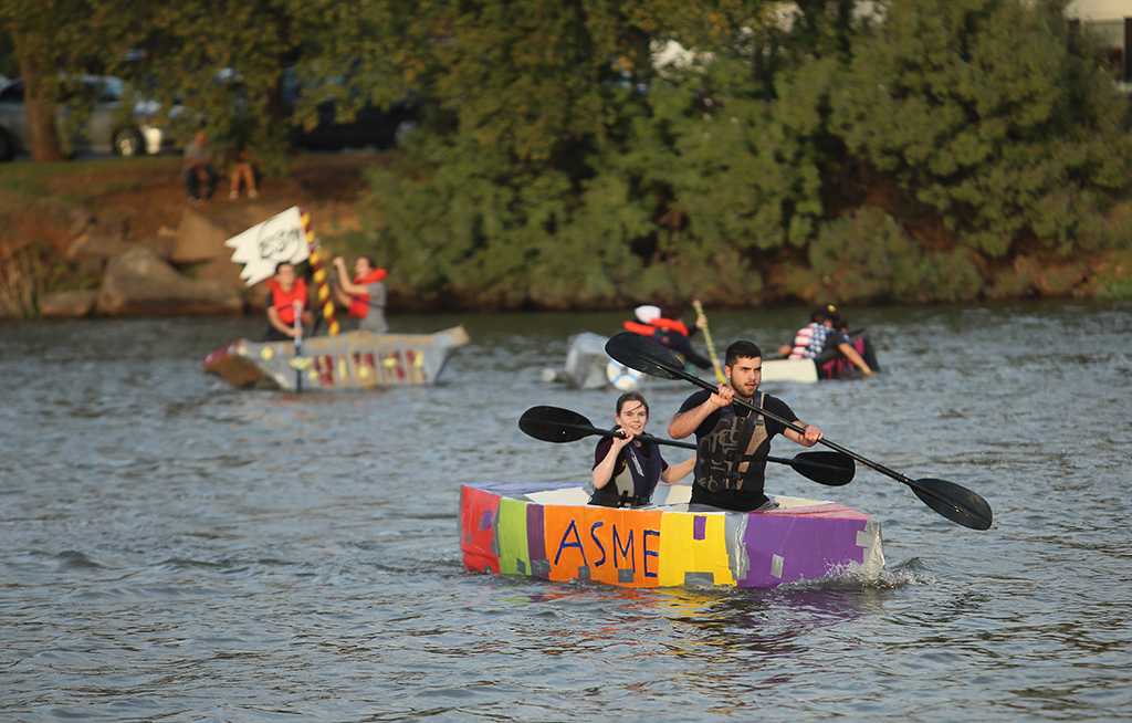 In the ASME boat, Clayton Masters, engineering junior, and Kyndall Diehm, engineering sophomore, placed first at the homecoming cardboard boat race on Sikes Lake Oct. 20, 2017. Photo by Bradley Wilson