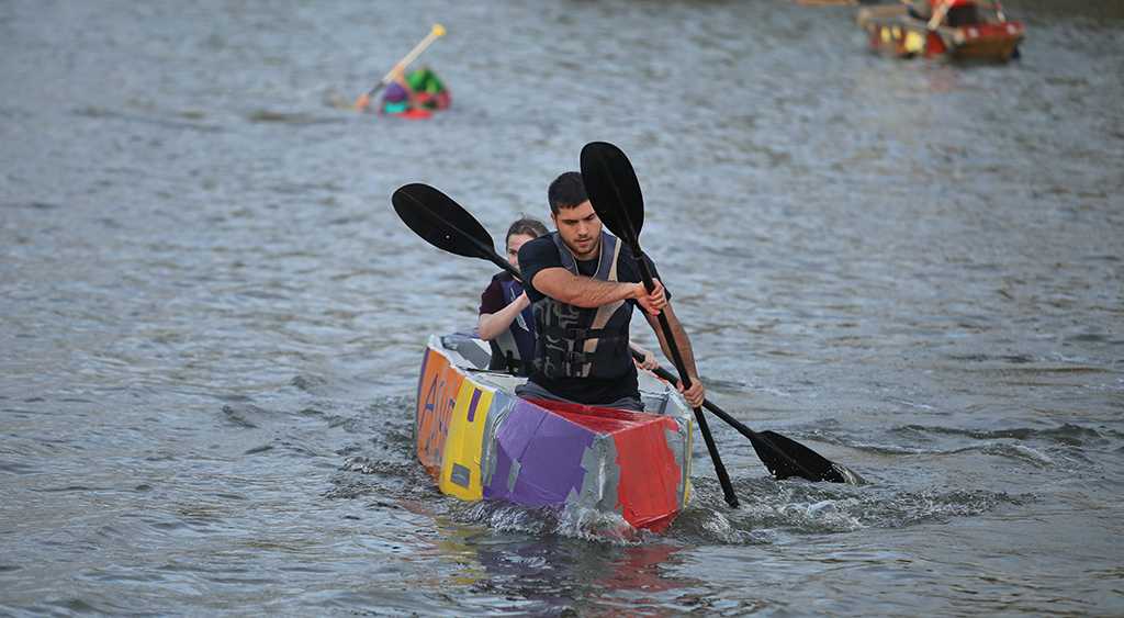 in the ASME boat, Clayton Masters, engineering junior, and Kyndall Diehm, engineering sophomore, placed first at the homecoming cardboard boat race on Sikes Lake Oct. 20, 2017. Photo by Bradley Wilson