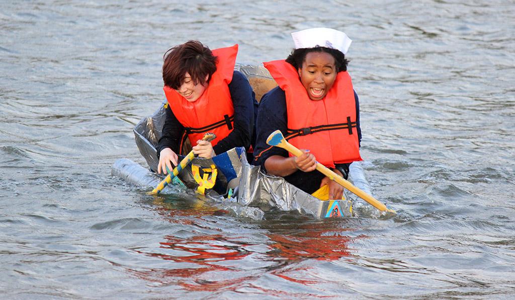 Nicole Smalls, theater sophomore, and Shae Dorsman, theater junior, freak out as they get closer to the shore and their boat begins to become submerged into Sikes Lake during the Homecoming Boat Race, Friday Oct. 20. Photo by Rachel Johnson