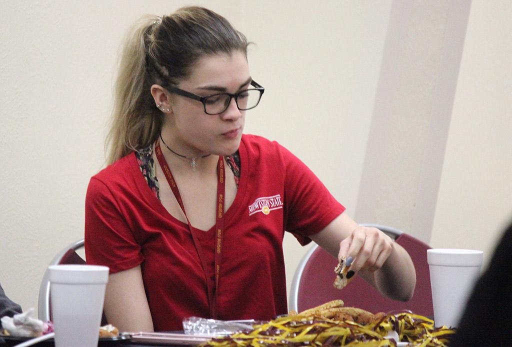 Brittni Vilandre, marketing sophomore, eats her food at Sikes Center during the Homecoming Fish Fry, Fri. OCt. 21, 2017. Photo by Rachel Johnson
