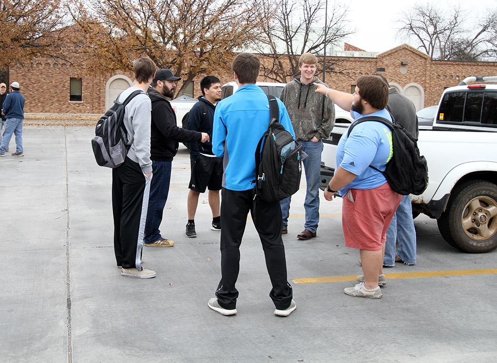 Students gather in the parking lot waiting for cars to clear out before leaving after a bomb threat forced the evacuation of the campus Dec. 8. Photo by Lauren Roberts
