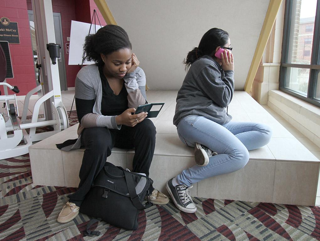 Demetria Samuel, radiology sophomore, and Dynana Amaya, radiology junior, wait in the Wellness Center for campus to open after a bomb threat forced the evacuation of the campus Dec. 8. Photo by Lauren Roberts