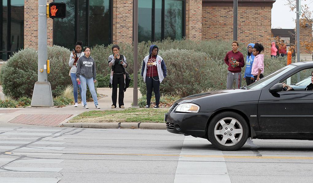 Students wait to cross the street after a bomb threat forced the evacuation of the campus Dec. 8. Photo by Lauren Roberts