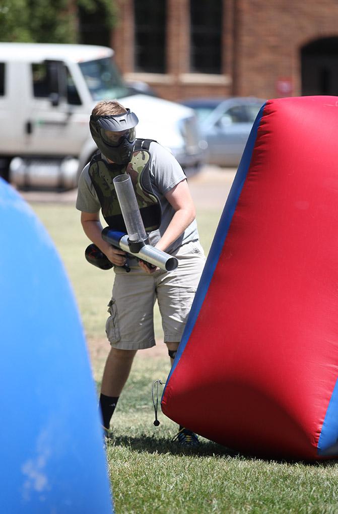 Theodore Hughes, mechanical engineer freshman, looks around an obstacle to shoot an opponent from the other team during a game of Bongo Ball held on quad, Sept. 9 . Photo by Rachel Johnson