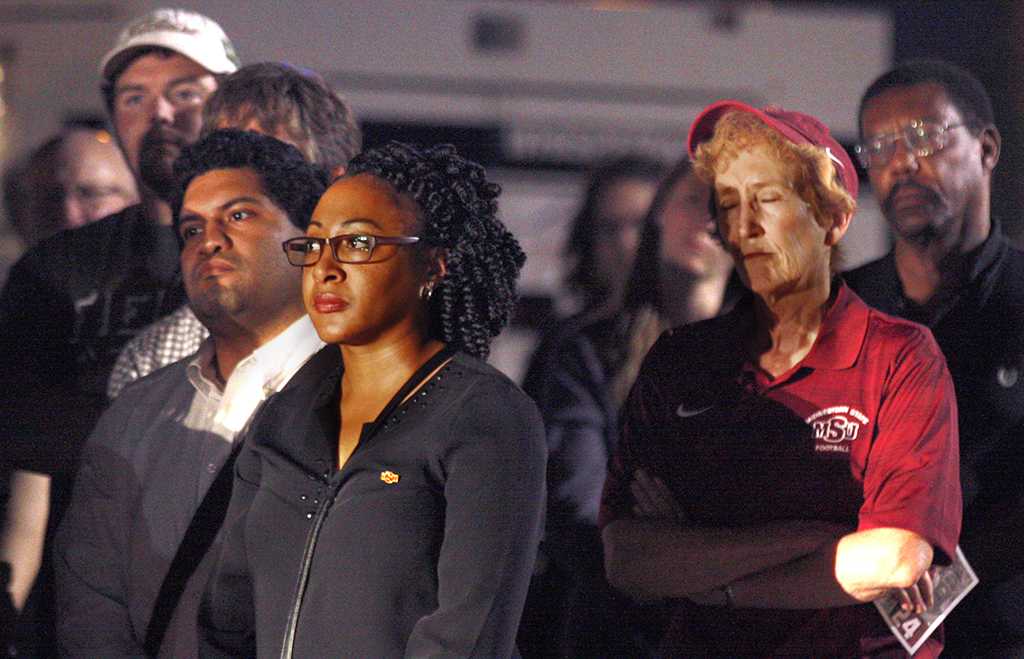 A.J. Lopez, social media coordinator, Syreeta Greene, director of equity, inclusion and multicultural affairs, and Suzanne Shipley, university president, at the candle light vigil in honor of Robert Grays, , on the Jesse Rogers Promenade on Sept. 21.  Photo by Justin Marquart