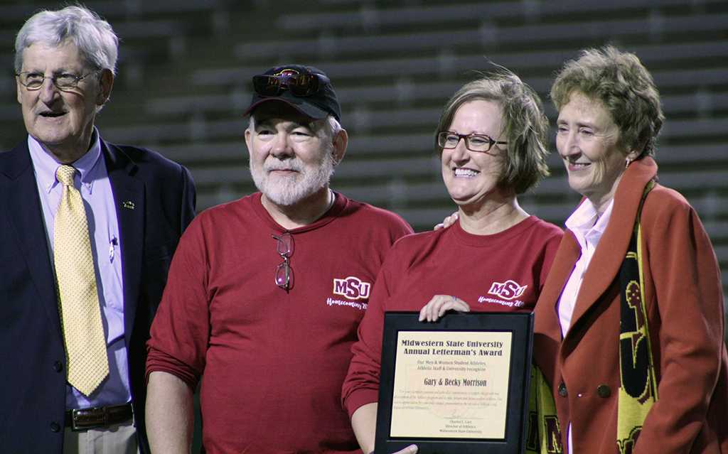 Athletic Director Charlie Carr and University President Suzanne Shipley present Gary and Becky Morrison with Midwestern State University Annual Letterman's Award at the Homecoming football game. 29th Oct. Photo by Bridget Reilly