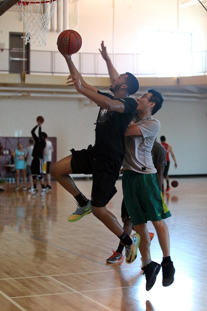 Jalal Elrosoul, excersize physiology sophomore, goes up for a layup and makes a point for his team, during the  Chi-Omega Basketball Tournament, Swishes for Wishes, Sat. March 28, 2015. Photo by Rachel Johnson
