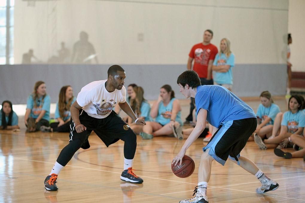Cooper Tisdale, pre-pharmacy freshman, stands off against Andre Shaw, grad assistant coach, to move up the court, during the Chi-Omega Basketball Tournament, Swishes for Wishes. Fab 5 beat Sticky Bandit, 27-20, in the championship game,  Saturday, March 28, 2015. Shaw said, "We did it to give back, bring back unity to the school, and help a good cause."  Photo by Francisco Martinez
