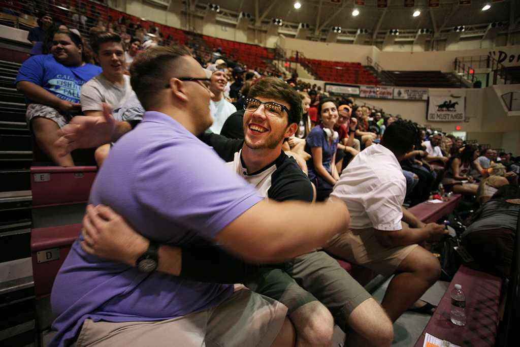 Brett LaFleur and Cody Park give each other hug as part of the speaker's talk at Midwestern State University Convocation. Photo by Bradley Wilson