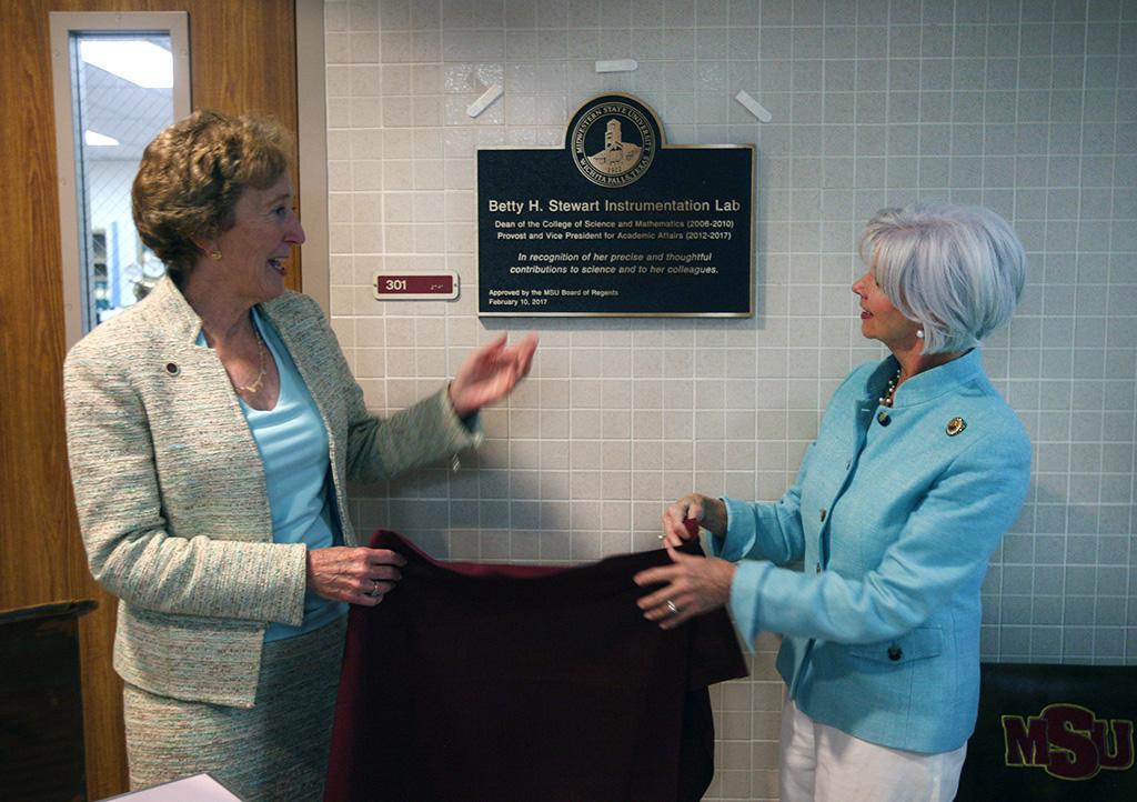 University President Suzanne Shipley and Board of Regents member Nancy Marks unveil the palque in honor of former provost Betty Stewart in Bolin hall. Photo by Bradley Wilson