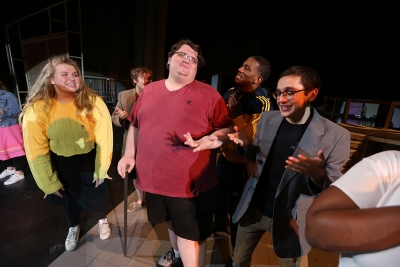 Cast members, including Shannon Howerton in the role Caldwell B. Cladwell, practice "Mr. Cladwell" at "Urinetown" rehearsal Jan. 24. Photo by Bradley Wilson