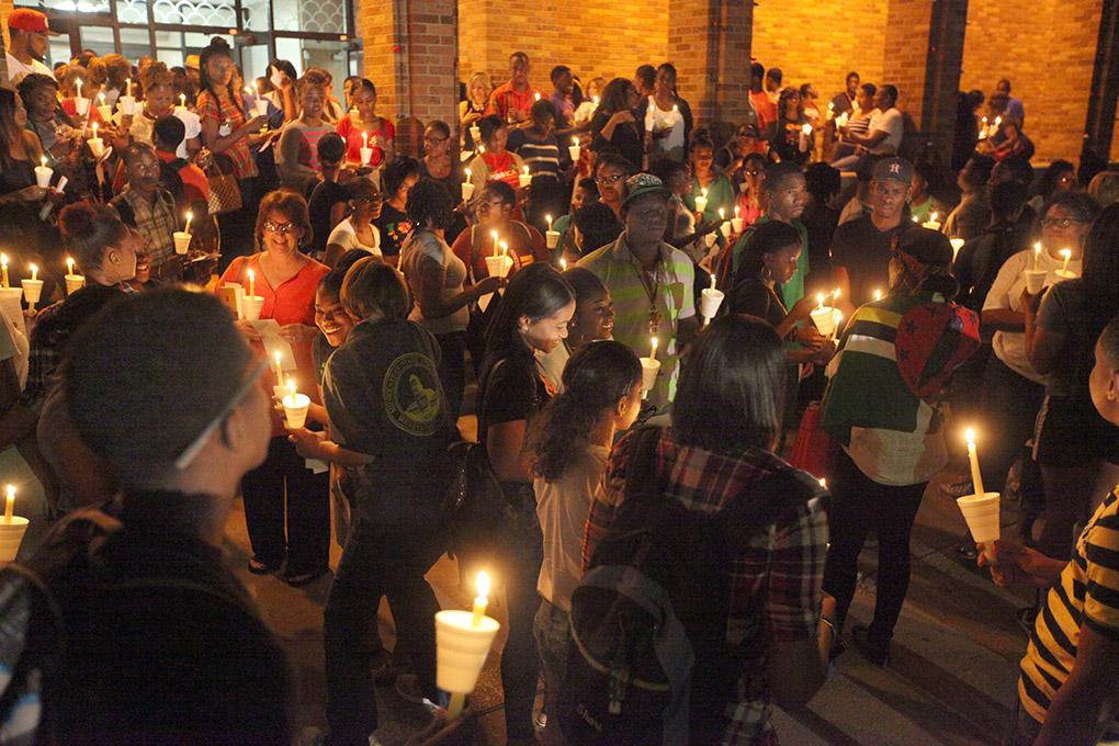 About 180 students and others gather outside of Bolin Hall with candles to honor the victims of the remnants of tropical storm Erika during the  Caribbean Student Organization Candlelight Vigil, Sept. 1. Photo by Francisco Martinez