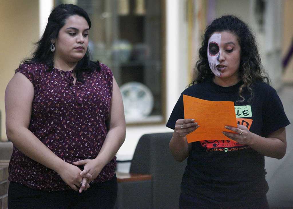 Brenda Adame, bilingual education sophomore, and Patricia Ramirez, bilingual education senior, welcome MSU students and guest during the Dia de los Muertos event held by multiple organizations in the Atrium, Wednesday, Nov. 1, 2017. Photo by Francisco Martinez