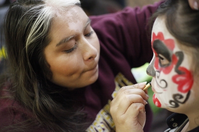 Rutth Mercado, mass communication junior, paints Fatima Chavez, attendee, face during the Dia de los Muertos event held by multiple organizations in the Atrium, Wednesday, Nov. 1, 2017. Photo by Francisco Martinez