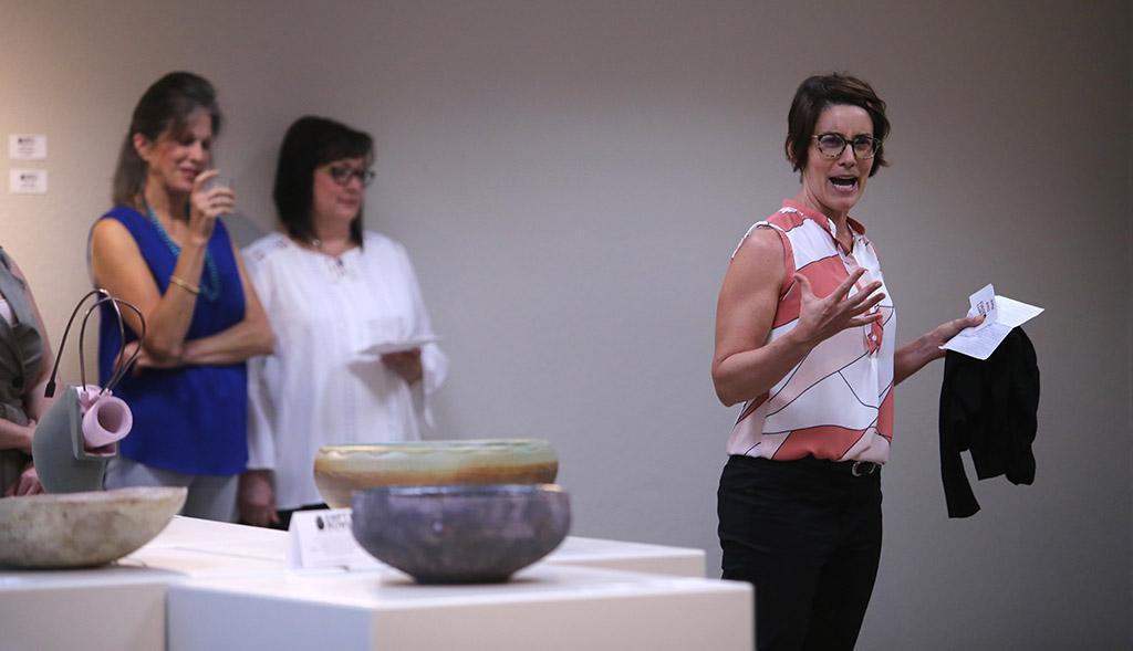 Kelly O'Briant, assistant professor of ceramics at the University of Dallas, announces the award-winning entries at the opening for Empty Bowls of Wichita Falls at the Wichita Falls Museum of Art. Photo by Bradley Wilson