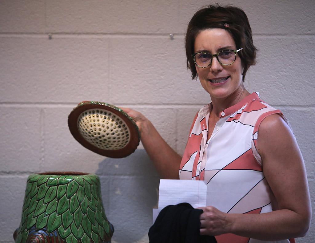 Kelly O'Briant, assistant professor of ceramics at the University of Dallas, announces the award-winning entries at the opening for Empty Bowls of Wichita Falls at the Wichita Falls Museum of Art. Photo by Bradley Wilson