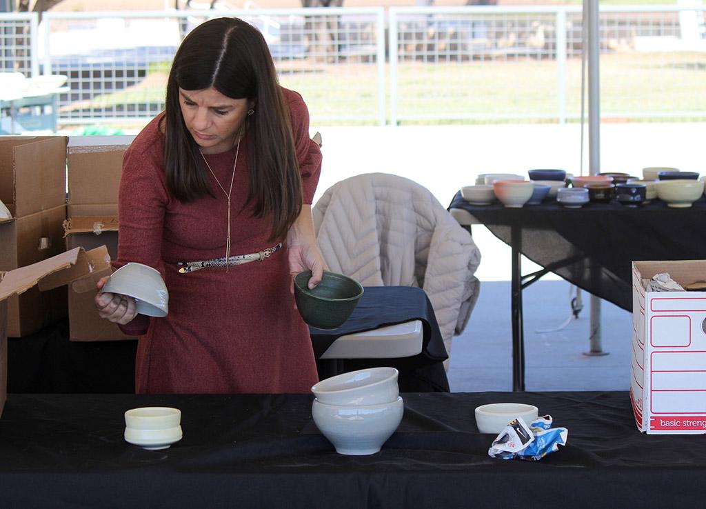 Tanya Gillen, 2nd vice chair for Wichita Falls food bank, sorts through the student made bowl during the Empty Bowls of Wichita Falls at Wichita Falls Museum of Art at MSU, Oct 10, 2017. Photo by Francisco Martinez