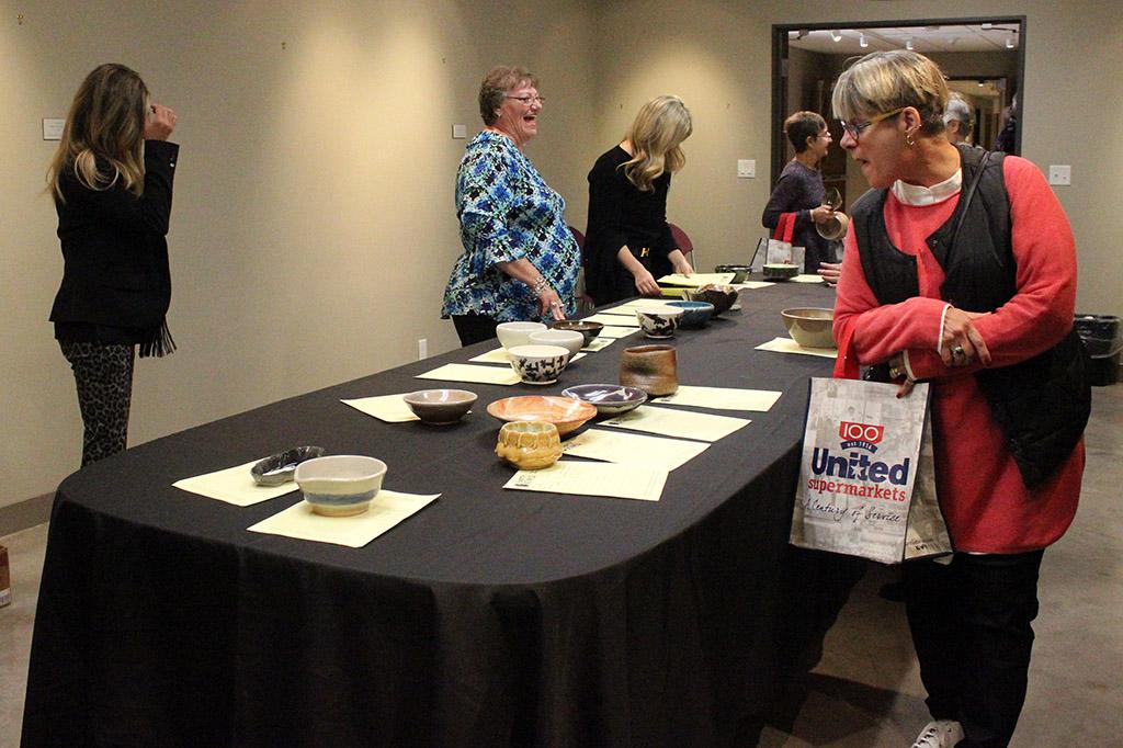People enter bids in the silent auction during the Empty Bowls of Wichita Falls at Wichita Falls Museum of Art at MSU, Oct. 10, 2017. Photo by Francisco Martinez