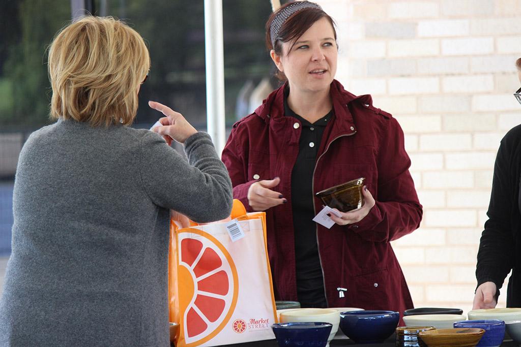 D'Ann Delcoure, 8th Street Coffee House vendor, collects her student made bowl during the Empty Bowls of Wichita Falls at Wichita Falls Museum of Art at MSU, Oct. 10, 2017. Photo by Francisco Martinez