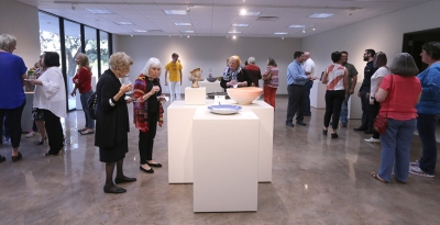 People look at the different bowls created by different artists at the Empty Bowls Gallery Reception held at the Wichita Falls Museum of Art at MSU Oct. 5. Photo by Rachel Johnson