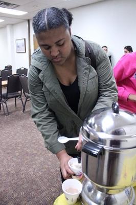 Gabby Duga, biology junior, gets hot chocolate with a concha in Clark Student Center Wichita 1 & 2 as a part of Finals Frenzy, Thurs. Dec. 7, 2017. Photo by Rachel Johnson