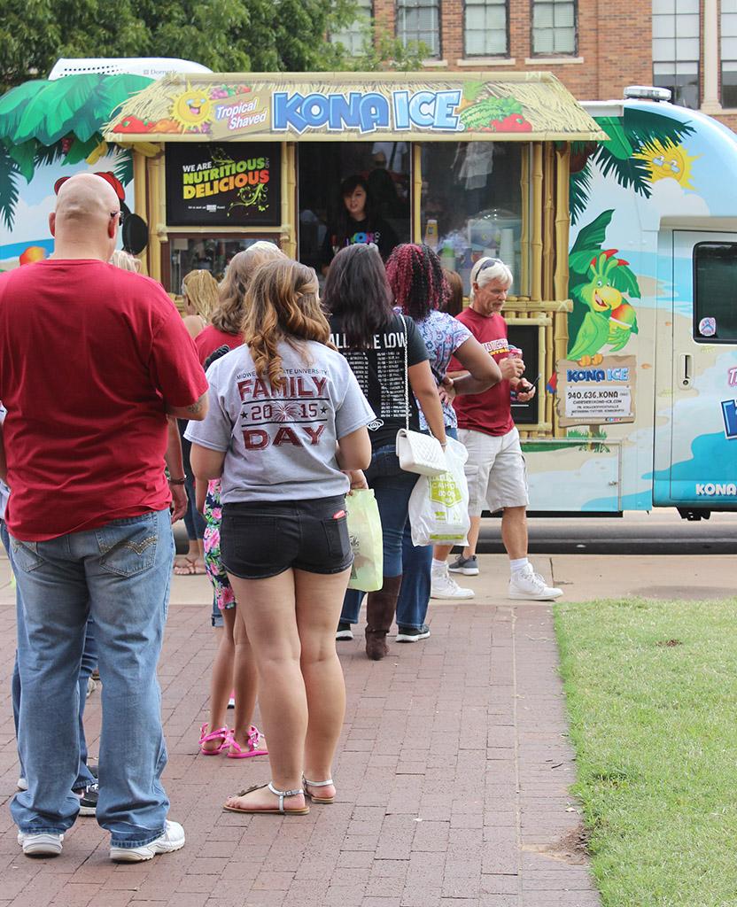 People wait in line for the free snowcones from Kona Ice parked on Council Drive as a part of Family Day, Sept. 26. Photo by Rachel Johnson