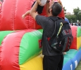 Marcel Campolina, excersize physiology graduate student, picks up his daughter, Eva Campolina, after she slides down one of the inflateable obstacle courses set up in the Quad by Dillard on Family Day, Sept. 26. Photo by Francisco Martinez