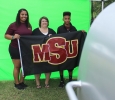 Sierra Jones, athletic training senior, Shana Hancock, mother of Sierra, and Devin Hancock, Sierra's brother, get their picture taken at one of the booths in the Quad put up for Family Day, Sept. 26. Photo by Rachel Johnson