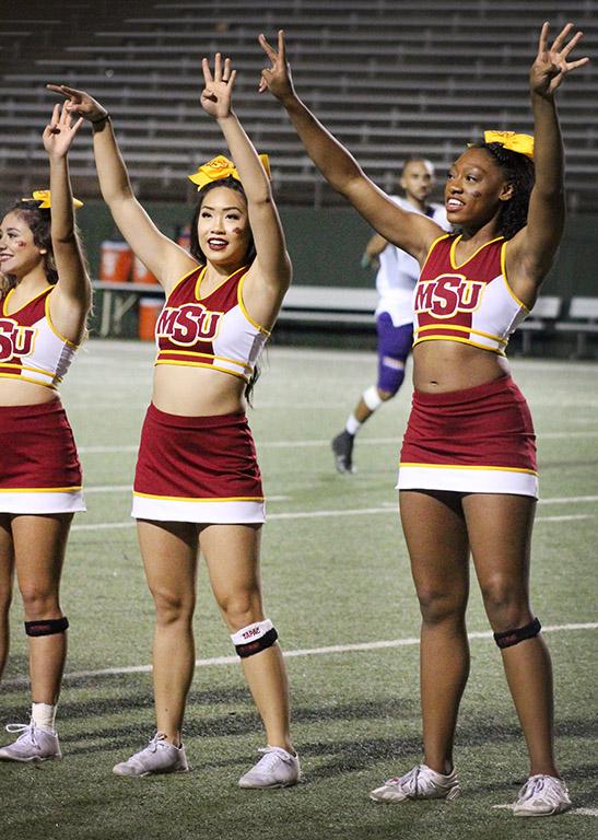 Kamerin Jones, early childhood education sophmore, and Abigail Phouleuanghong, early childhood education junior, show cheer pride during the Mustangs vs Western New Mexico football game held in the Wichita Falls Memorial Stadium. Sept. 30. Photo by Marissa Daley
