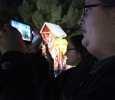 Amelia Latham, nursing freshman, and Catherine Stepniak, psycology freshman, take pictures of their favorite displays at the Fantasy of Lights during the Opening Ceremony on Monday night infront of the Hardin building. Photo by Rachel Johnson