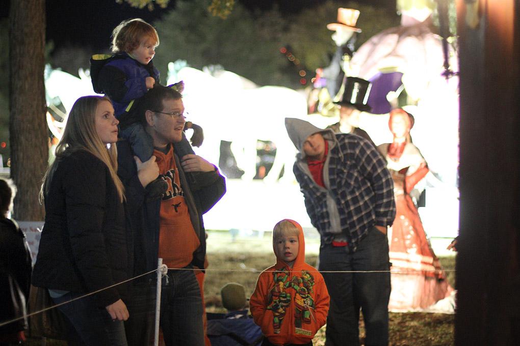 Alyssa, Michael Johnston and their son Jack look at the christmas carol display at the MSU-Burns Fantasy of Lights opening ceremony Monday night in the front lawn of the Harden Administration building. The fantasy of lights has individual displays with themes or characters from children's stories, fairy tales and holiday themes. The fantasy of lights display opened early this year before Thanksgiving and will continue through Dec. 28. The lights turn on at dusk and turn off at 10 p.m. Sunday through Thursday and 11 p.m. Friday and Saturday. Photo by Lauren Roberts