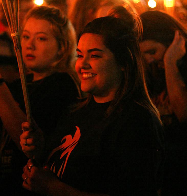 Autumn Duval, early childhood education freshman, enjoys the torchlight parade at MSU on Thursday, Oct. 19, 2017. Photo by Harlie David