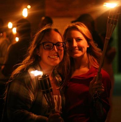 Keelie Ralston, kinesiology junior, and Alicia Mayhugh, kinesiology junior, get ready to start the torchlight parade at MSU on Thursday, Oct. 19, 2017. Photo by Harlie David