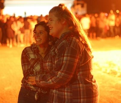 Nicole Buchanan, resident assistant, and Shelby Emerson, education senior, enjoy the bonfire hosted by MSU during homecoming week at the student parking lot on Thursday, Oct. 19, 2017. Photo by Harlie David