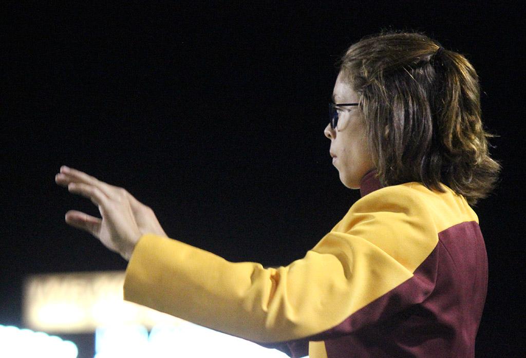 Desire Graves, performance junior, leads the Golden Thunder Marching Band as one of the drum majors during the halftime. Photo by Rachel Johnson