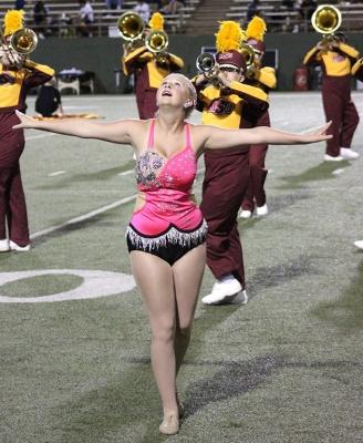 Alexis Maggard, spech education freshman, performs her routine with her batons while the band performs "Changing Channels" for the Texas A&M Commerce vs MSU football game held at the Memorial Stadium, Oct. 7. Photo by Marissa Daley