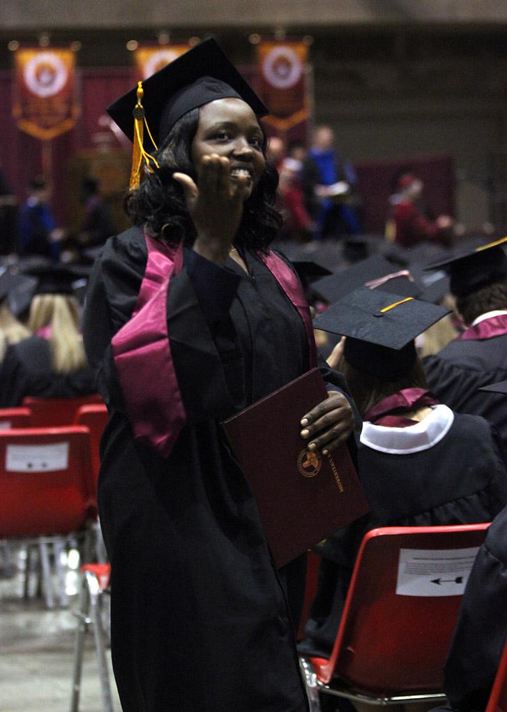 A student blows a kiss to the people there for her in the audience at Midwestern State University fall graduation, Dec. 13, 2014 in Wichita Falls, Texas. Photo by Rachel Johnson
