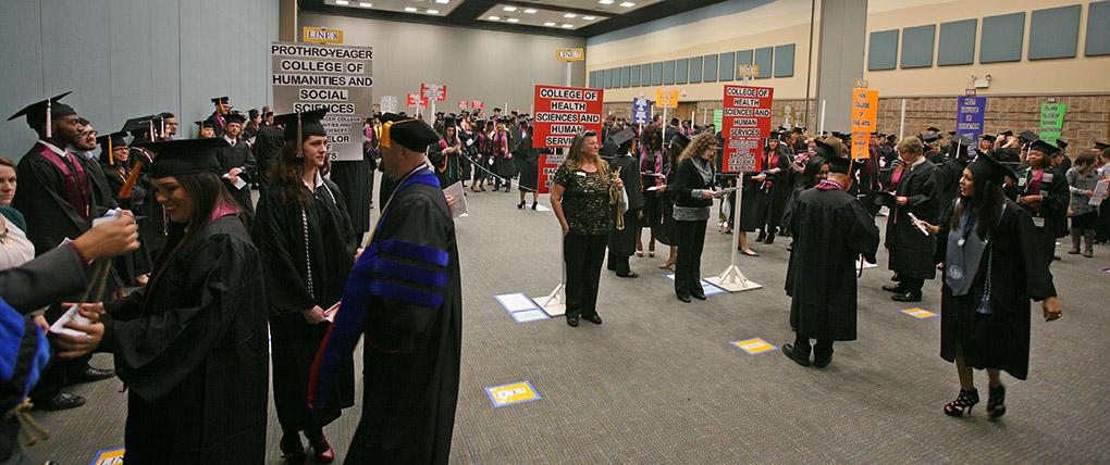 Students are orgnized by major as they wait to be moved to the coliseum at Midwestern State University fall graduation, Dec. 13, 2014 in Wichita Falls, Texas. Photo by Rachel Johnson