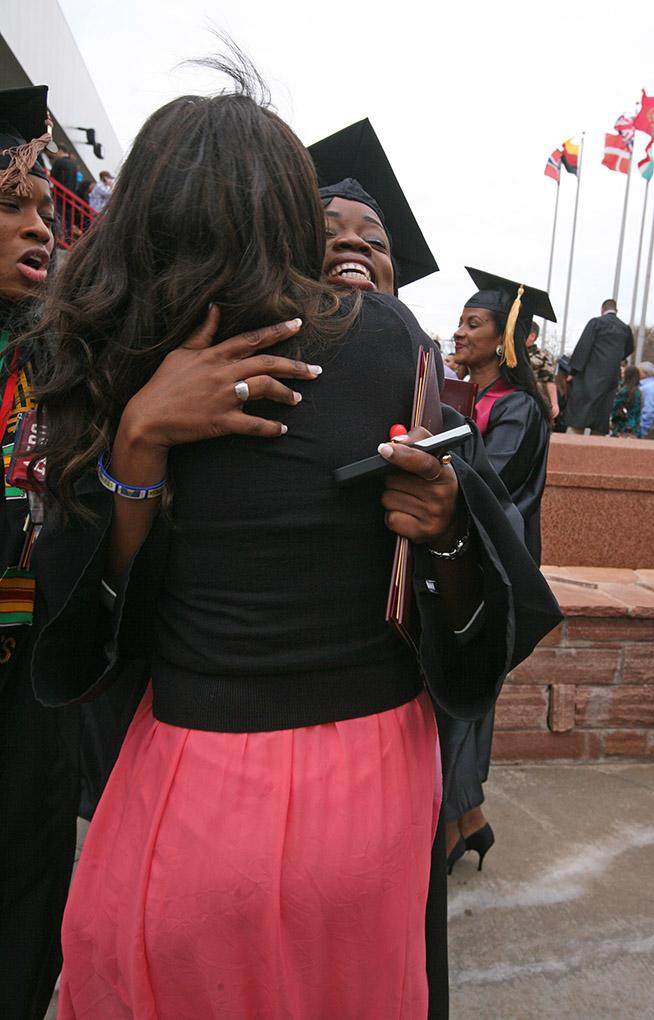 Leona Sandiford, theatre, hugs her friends and family at Midwestern State University fall graduation, Dec. 13, 2014 in Wichita Falls, Texas. Photo by Rachel Johnson