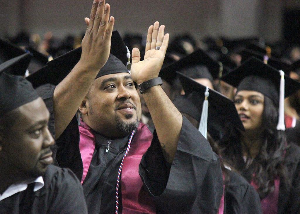 Brandon Torres, BAAS, claps for his family, friends, and supporters at the end of Commencement, held ing kAy YEager Coliseum, May 14. Photo by Rachel Johnson