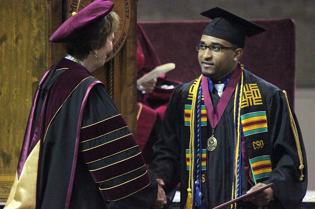 Sadiq Bage, bachelor of art from prothro yeager, shakes Suzanne Shipley's, university president, hand while walking the stage during Commencement, May 14. Photo by Rachel Johnson