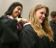 Esmeralda Toral, finance, helps Jaci Meurer, general business, put her white collar on while waiting for Commencement to start, May 4. Photo by Rachel Johnson