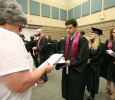 Michael Pesquieda, sports and leisure, waits in line, to be given instructions on where to stand with his department, while waiting for Commencement to begin, May 14. Photo by Rachel Johnson