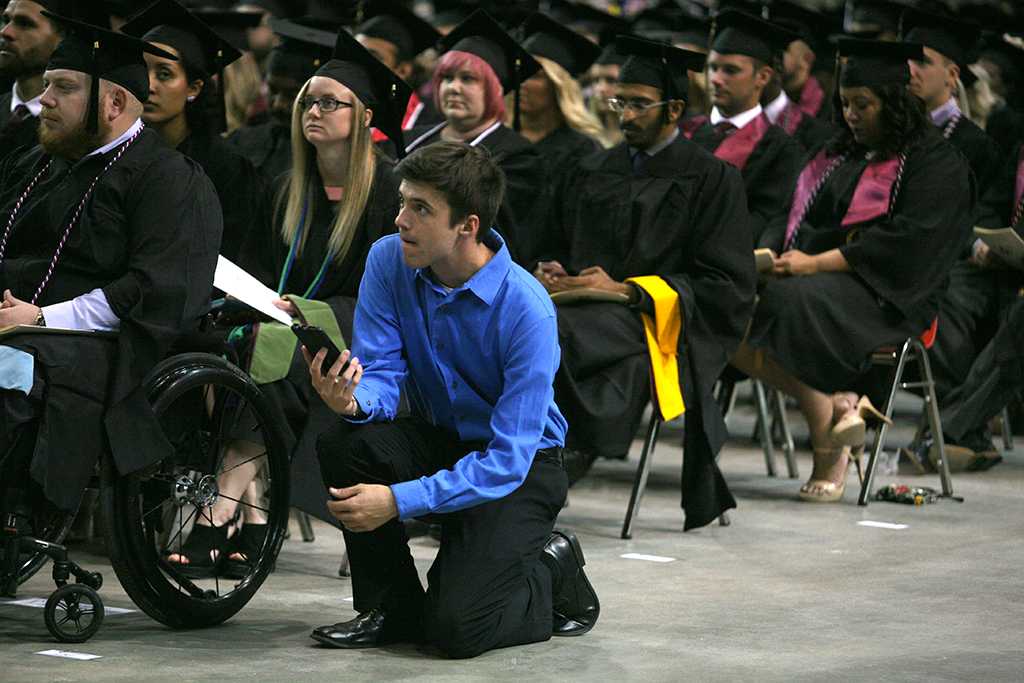 Tyler Manning records part of the graduation speech at Midwestern State University graduation, May 13, 2017. Photo by Bradley Wilson