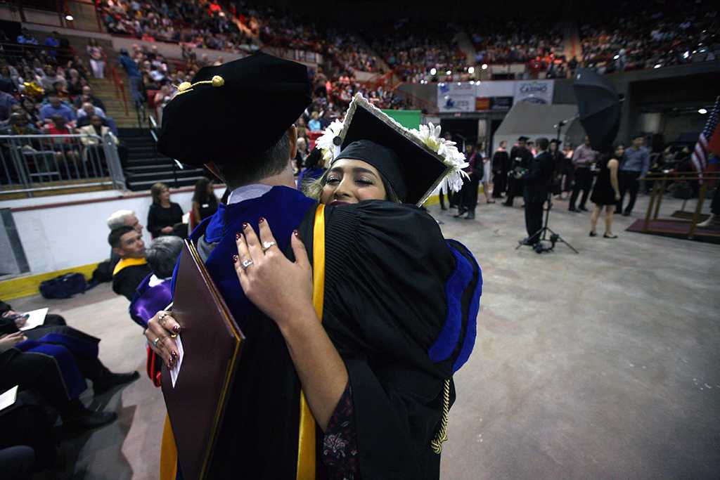 Yvette Ordonez hugs Jim Sernoe, mass communication associate professor, at Midwestern State University graduation, May 13, 2017. Photo by Bradley Wilson