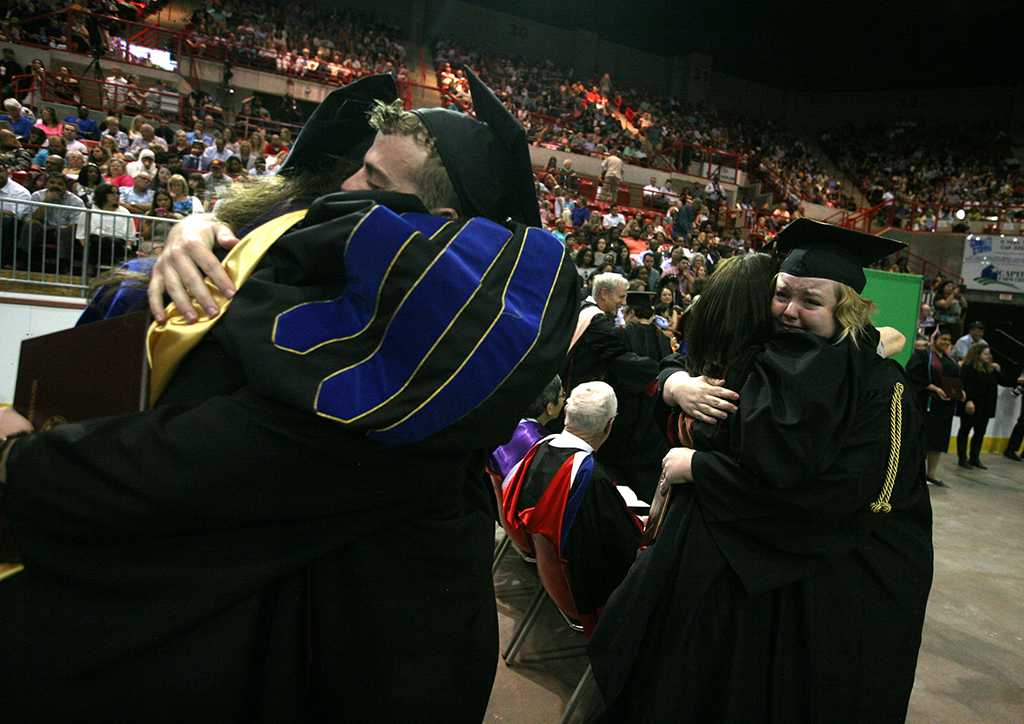 Theater students hug instructors at Midwestern State University graduation, May 13, 2017. Photo by Bradley Wilson