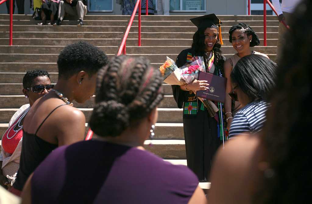 Raina Winston Biology graduate, poses with her family after Midwestern State University graduation, May 13, 2017. Photo by Bradley Wilson