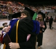 Megan Piehler hugs mass communication associate professor Jim Sernoe at Midwestern State University graduation, May 13, 2017. Photo by Bradley Wilson