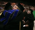 A theater student hugs Karen Dabney while Houston Pokorney hugs Christie Maturo at Midwestern State University graduation, May 13, 2017. Photo by Bradley Wilson