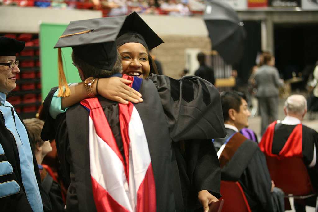 Brooke Draper, mass communication graduate, hugs Bradley Wilson, assistant professor of mass communication, at Midwestern State University graduation, May 10, 2014. Photo by Ethan Metcalf